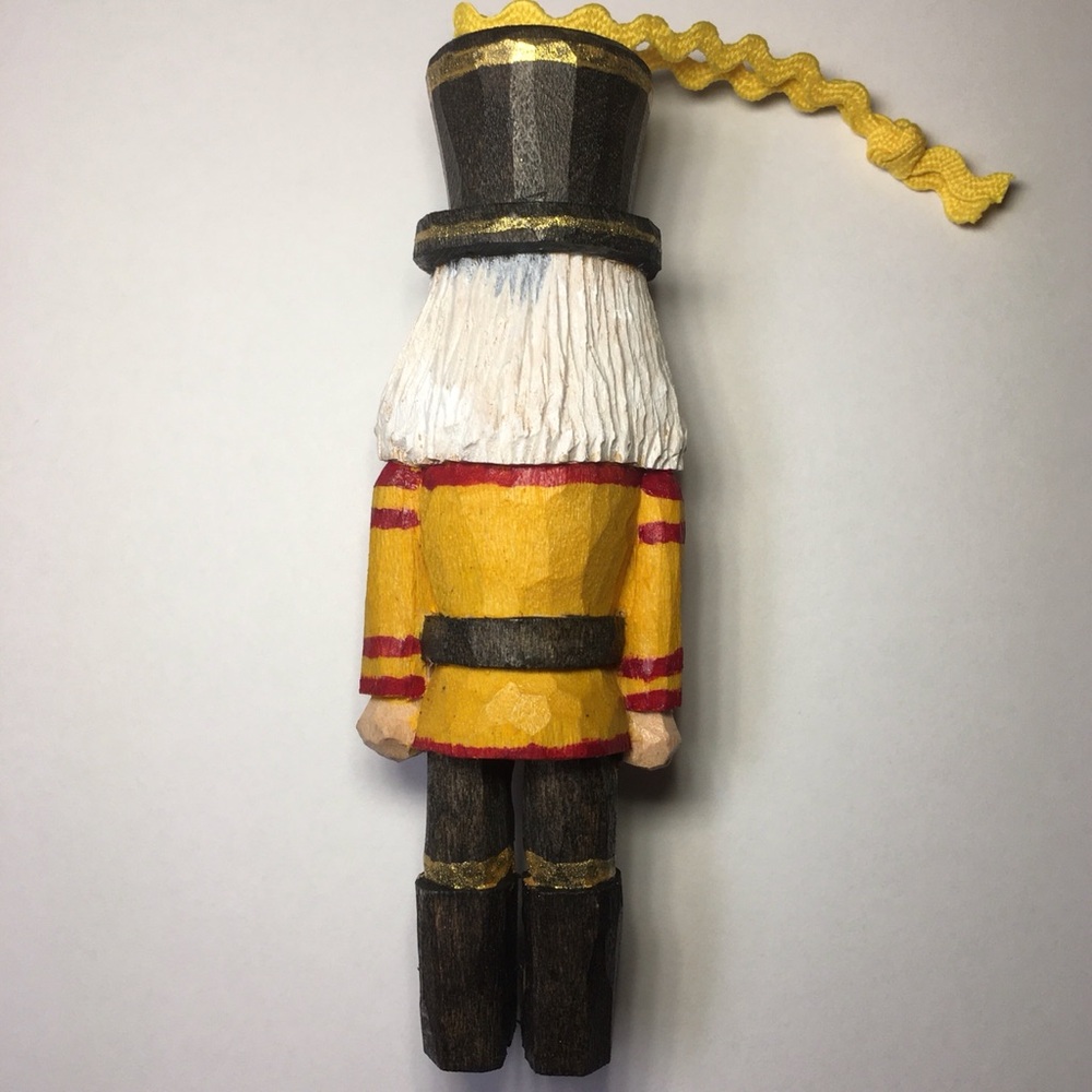Hand Carved Yellow and Red Nutcracker Ornament - Picture 2 of 3